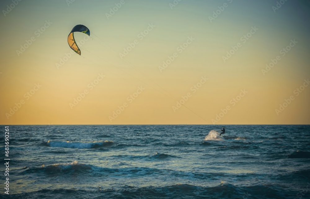 Beauty Photo of a Surfer away on a board in the open sea against a clear sky Beauty Photo of a Surfer away on a board in the open sea against a clear sky