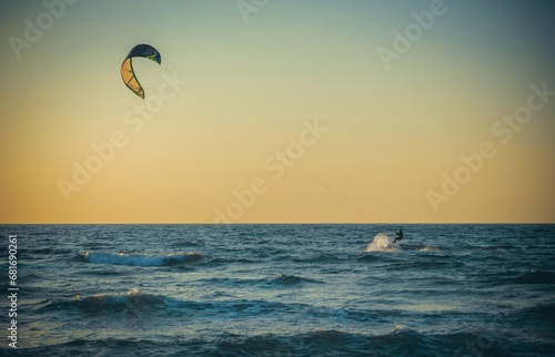 Beauty Photo of a Surfer away on a board in the open sea against a clear sky
