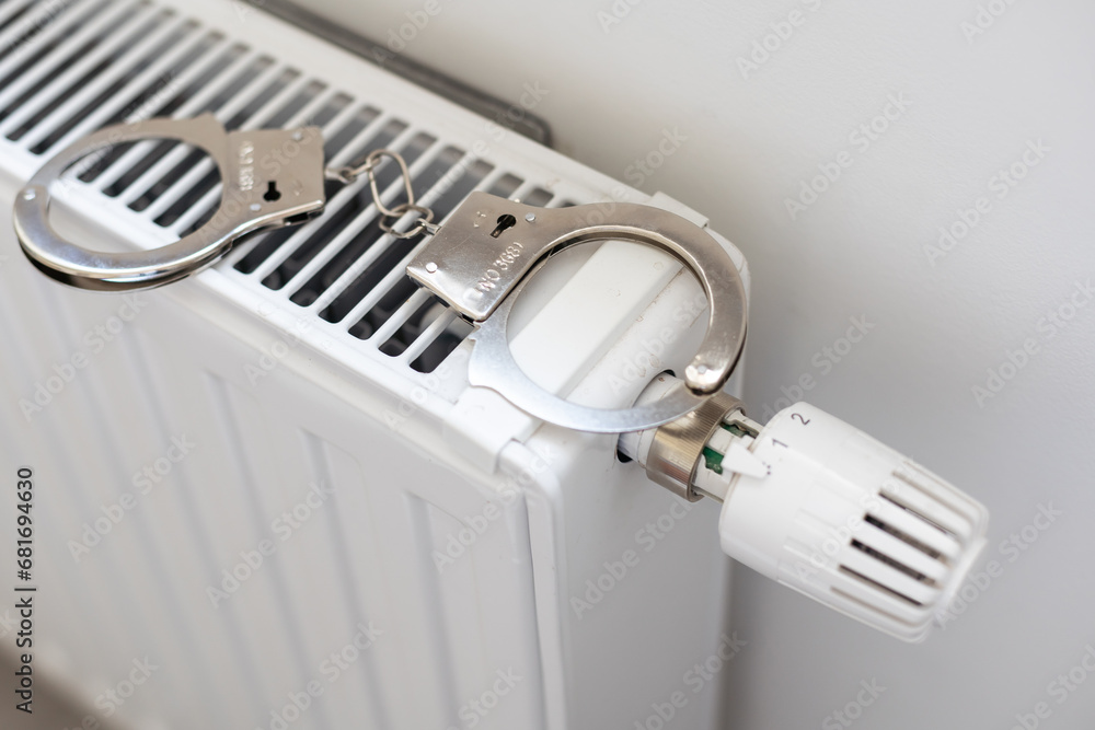 Handcuffs on the radiator. Police handcuffs and collar. Handcuffs on the radiator. Police handcuffs and collar.