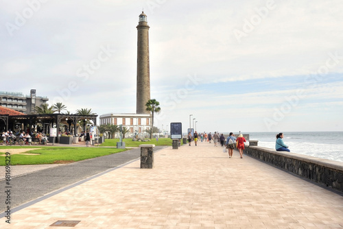 Tourists stroll on the Meloneras seafront in Gran Canaria, Canary Islands photo