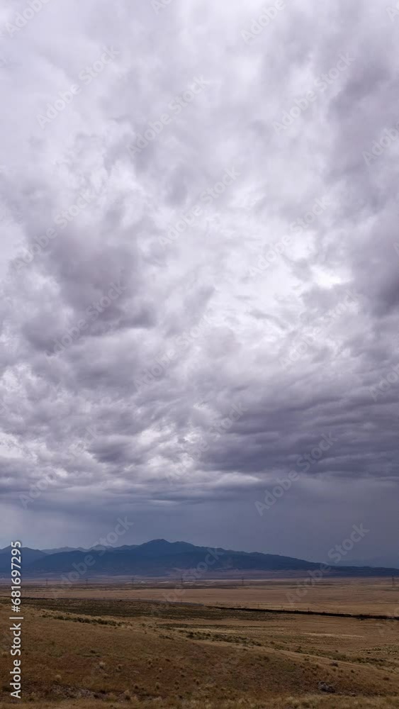 Vertical Timelapse of clouds circling the sky following a storm over desert landscape near Vernon, Utah. Vertical Timelapse of clouds circling the sky following a storm over desert landscape near Vernon, Utah.