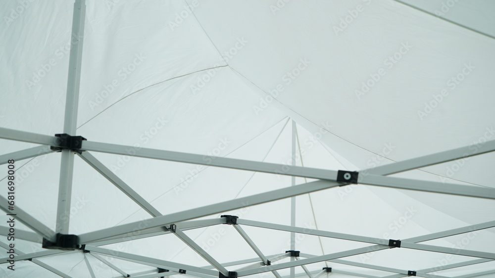 Ceiling of connected white canopy substructure
