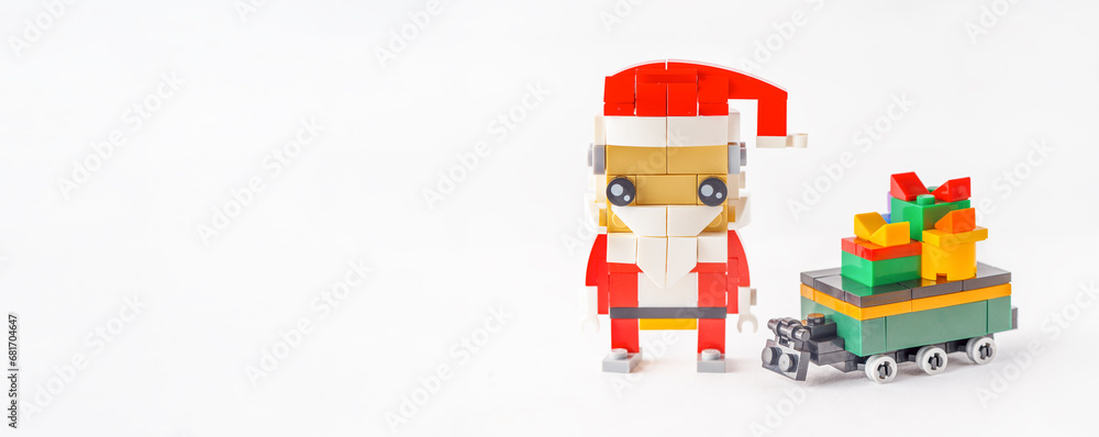 Merry Christmas Concept: Toy-Built Santa's Sleigh and Gifts Made from Bright plastic constructor. Banner. Copy space Merry Christmas Concept: Toy-Built Santa's Sleigh and Gifts Made from Bright plastic constructor. Banner. Copy space