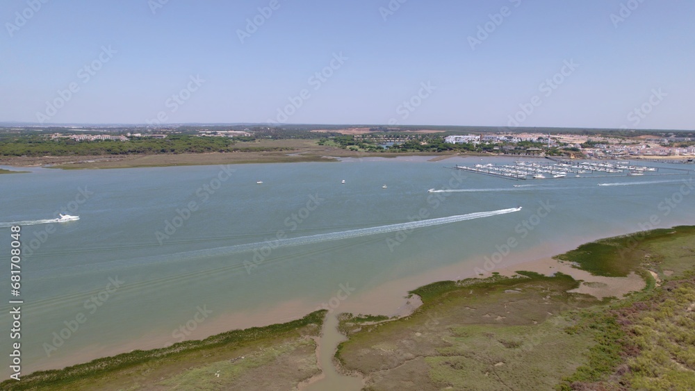 Motor boats in the estuary with the sea in the background Aerial view marshes with many boats Spain
