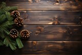 Dark wooden background with pine cones and fir tree branches. New Year, Christmas and holidays greeting card, frame, banner. Flat lay, top view with copy space