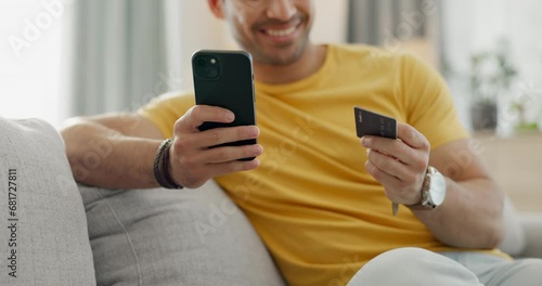 Hands, credit card and phone on sofa for online shopping, e commerce payment or internet subscription at home. Happy man relax on couch with mobile app banking, loan or sign up for streaming service photo