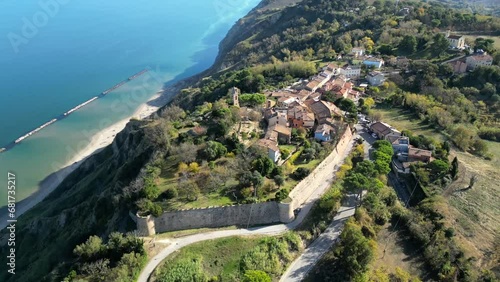 Italy, November 20, 2023 - aerial view of the medieval village of Fiorenzuola di Focara immersed in the San Bartolo park. We are located in the province of Pesaro and Urbino in the Marche region photo