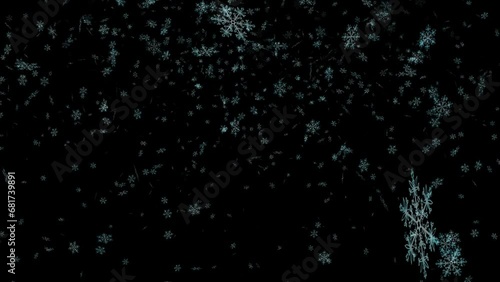 It's snowing on a black background, snowflakes are swirling. photo