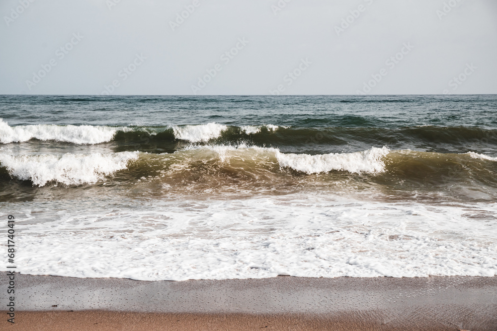 View at sea waves on a beach with massive foam, nature background