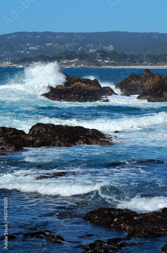 waves crash against rocks in Carmel Bay