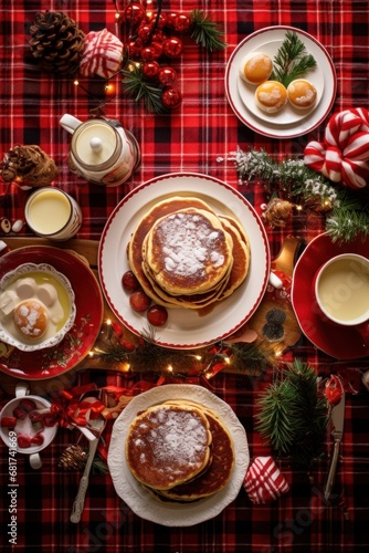 table set with Christmas-themed crockery, including pancakes, eggs, bacon, an...