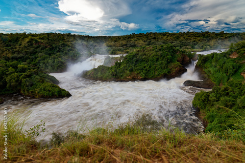 Murchison Falls National Park in Uganda  beautiful water falls on the river Victoria Nile  rainbow above the Uhuru falls and Kabarega falls waterfall in Africa
