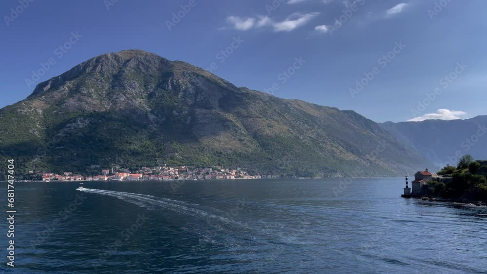View of the historical town of Perast in the famous Bay of Kotor on a beautiful sunny day with blue sky and clouds in summer, Montenegro. View of the historical town of Perast in the famous Bay of Kotor on a beautiful sunny day with blue sky and clouds in summer, Montenegro.