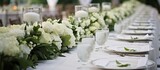 In the midst of a stunning summer wedding, the vintage-inspired table design showcased the beauty of nature with an array of white floral arrangements, prominently featuring elegant roses as a symbol
