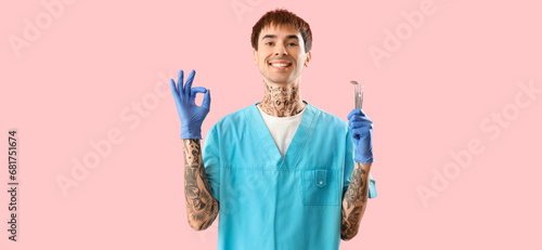 Male tattooed dentist with ...