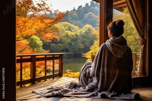 Girl meditating on the veranda in autumn