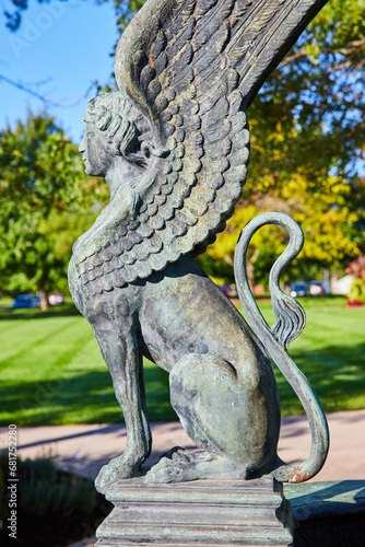 Sphinx statue side view on bright summer day with sunny garden in background, Muncie Indiana photo