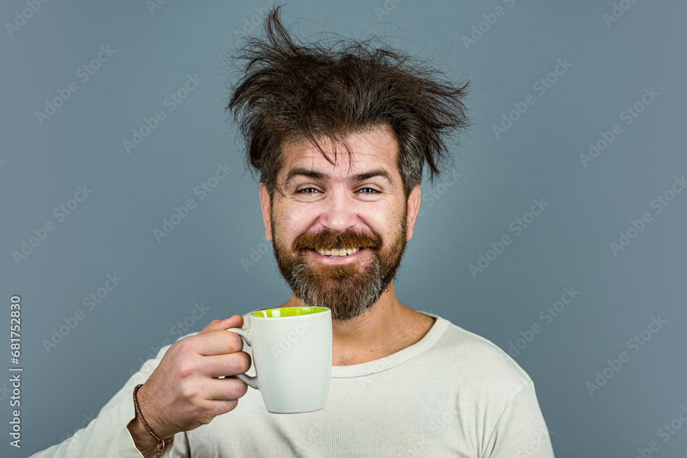 Mans holds cup of coffee, tea. Morning tea. Good morning. Man with tea cup. Hipster man with cup of coffee. Bearded man smiling after good morning. Wake up. Happy day. After morning tea. Mans holds cup of coffee, tea. Morning tea. Good morning. Man with tea cup. Hipster man with cup of coffee. Bearded man smiling after good morning. Wake up. Happy day. After morning tea.