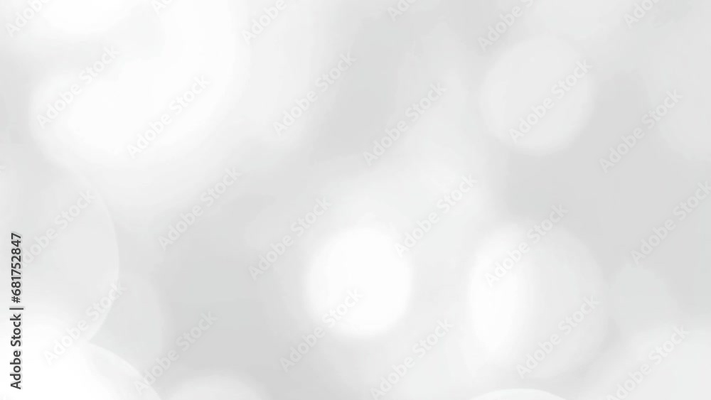 Peaceful white video background with white rotating bokeh rings.