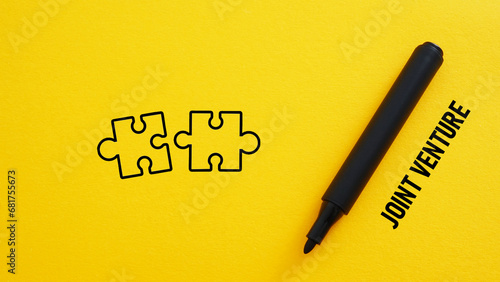Slika na platnu Joint venture is shown using the text and picture of the pieces of puzzle