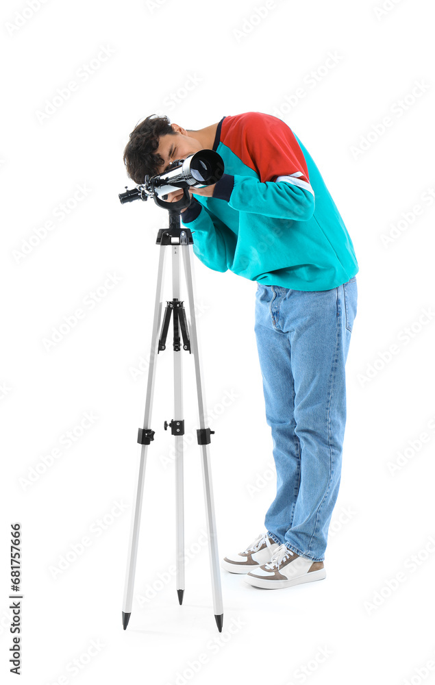 Young man looking into telescope on white background