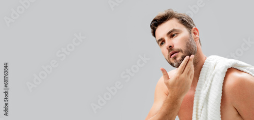 Banner of man with perfect skin touch face after shaving. Skin care healthcare cosmetic procedures concept. Close up man looking in mirror, sensitive skin, cosmetology treatment. Skin care. photo