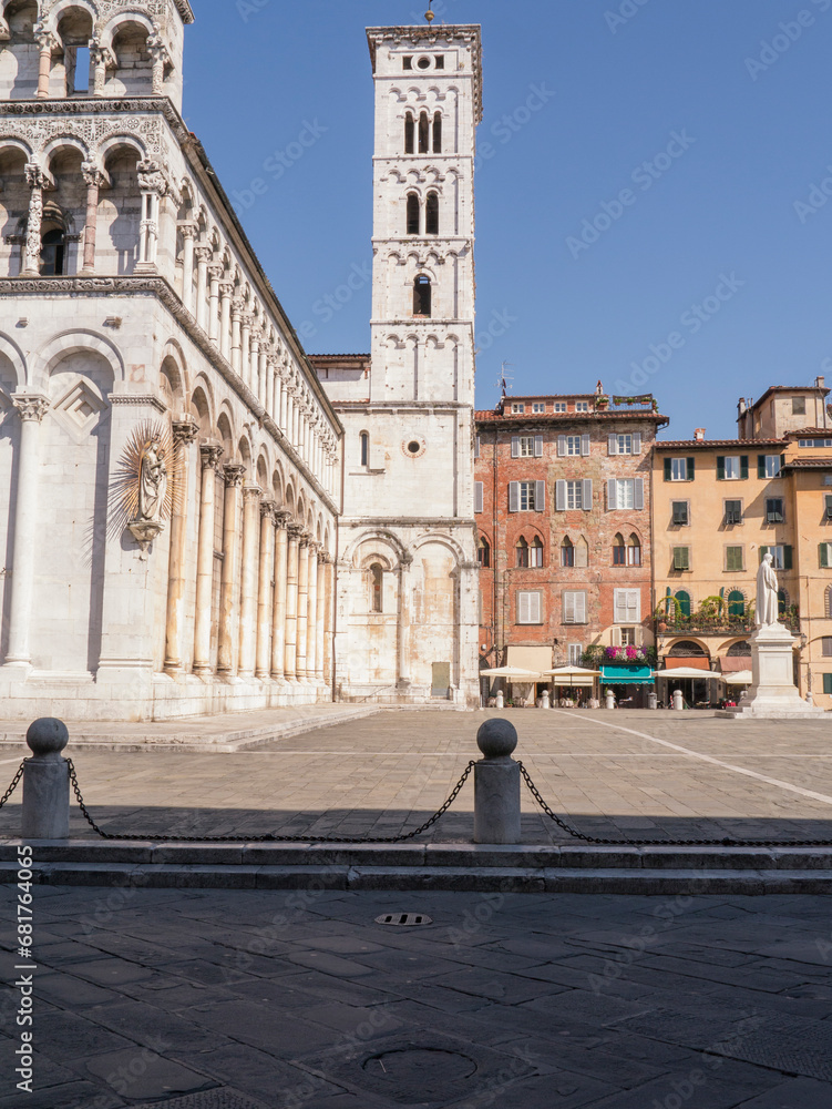 Glimpse of square San Michele with church and statue in Lucca, Tuscany, Italy