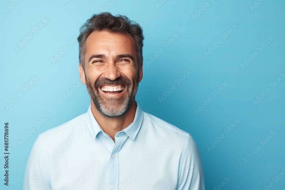 Portrait of a happy middle-aged man on a blue background Portrait of a happy middle-aged man on a blue background