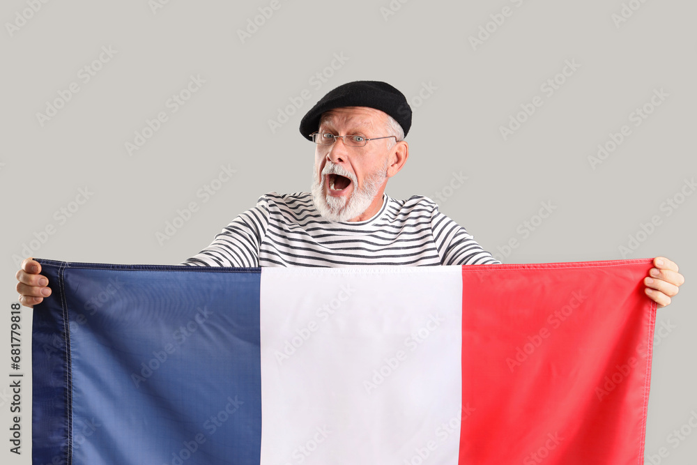 Senior man with flag of France on light background Senior man with flag of France on light background