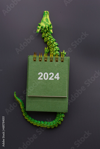 new year calendar and green dragon on a dark background