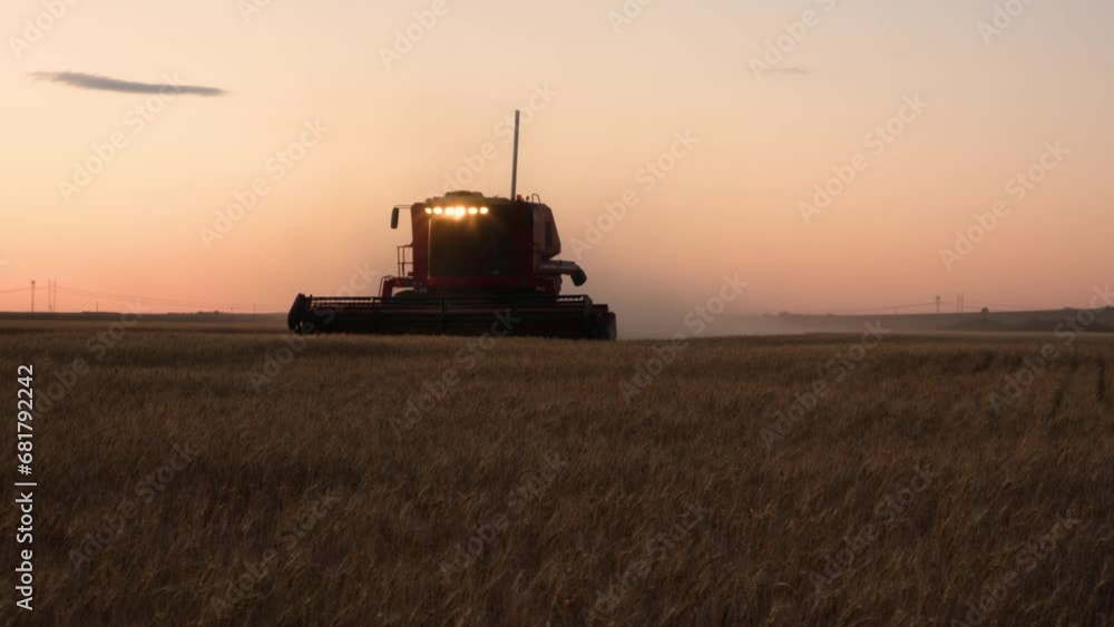 Combine harvester in a field at dusk coming towards the camera signaling with lights. 4K Combine harvester in a field at dusk coming towards the camera signaling with lights. 4K