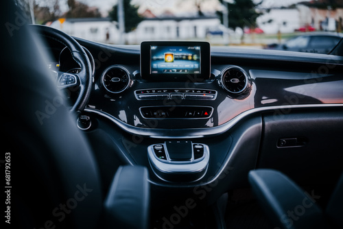 Modern car interior with big multimedia screen, sport steering wheel