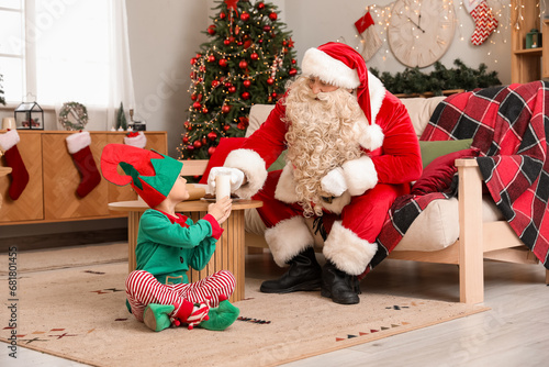 Santa Claus and cute little...
