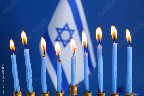 Menorah with burning candle...