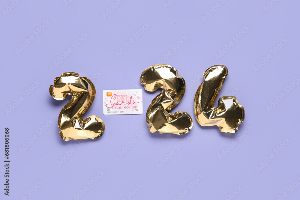 Figure 2024 made of foil balloons and gift card on color background Figure 2024 made of foil balloons and gift card on color background