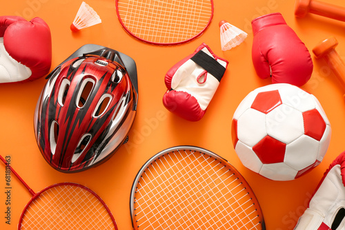 Fototapeta Naklejka Na Ścianę i Meble -  Composition with different sports equipment on orange background