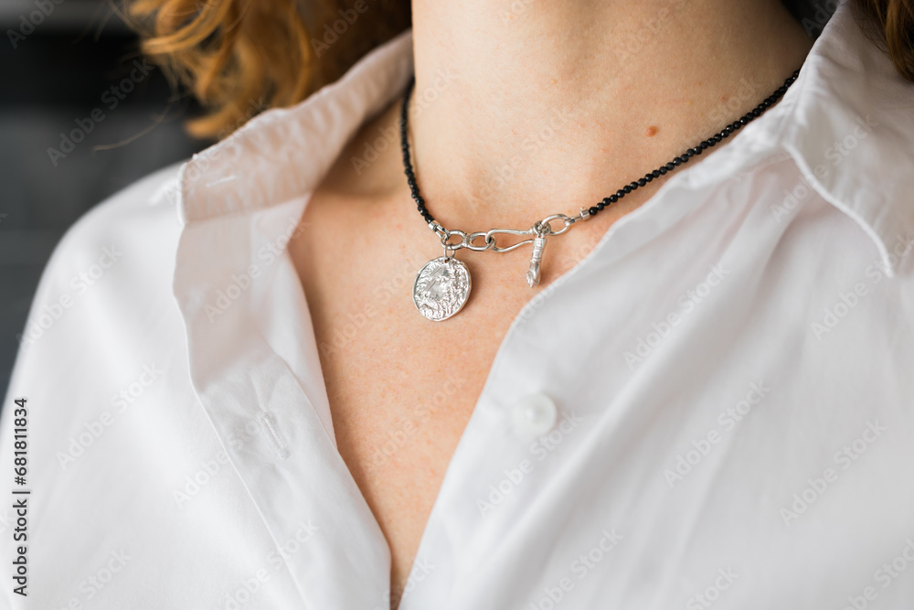 Female with silver pendant close-up. Image for e-commerce, online selling, social media, jewelry sale. Handmade jewelry Female with silver pendant close-up. Image for e-commerce, online selling, social media, jewelry sale. Handmade jewelry