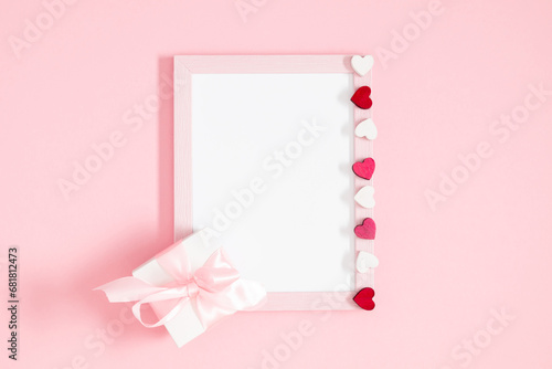 Valentine's Day composition. Photo frame and hearts on pastel pink background. Wedding. Birthday. Happy woman's day. Mothers Day. Flat lay, top view, copy space © prime1001
