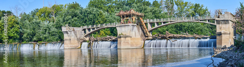 Maumee River Dam Fort Wayne, IN panorama on bright and sunny summer day with logs over waterfalls