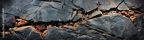 Textured and Cracked Rock Formation in Shades of Black, Brown, and Grey