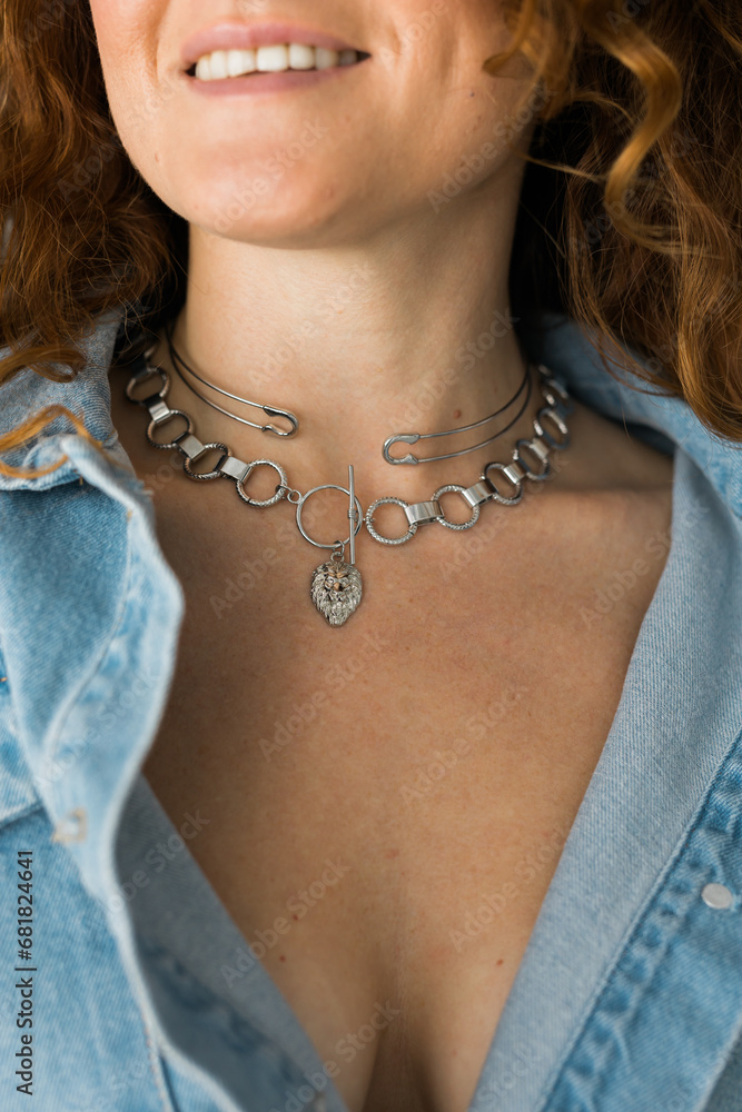 Close-up woman wearing beautiful luxury big necklace. Handmade jewellery and accessories