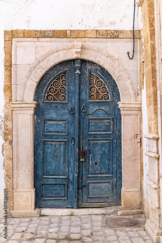 A blue keyhole, or Moorish, arch door on a house near the Tunis Souk. © Emily_M_Wilson