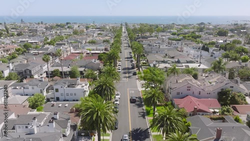Drone shot of Newport Beach houses and street at the Pacific Ocean, Corona Del Mar, California, West Coast, USA. Birds eye view of residential neighborhood located at Laguna Beach, 4k footage 