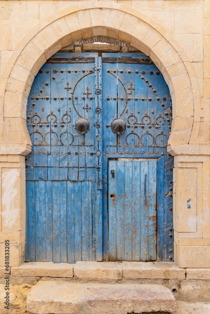 A blue door in a keyhole arch, also known as a Moorish Arch.
