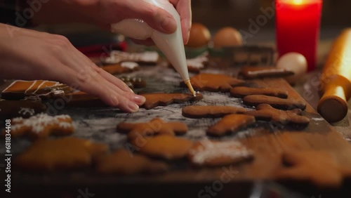 Sweet. A housewife dressed as a baker professionally applies a festive design in her home kitchen. Caring wife decorates Christmas cookies, observes customs of family holidays, Thanksgiving photo