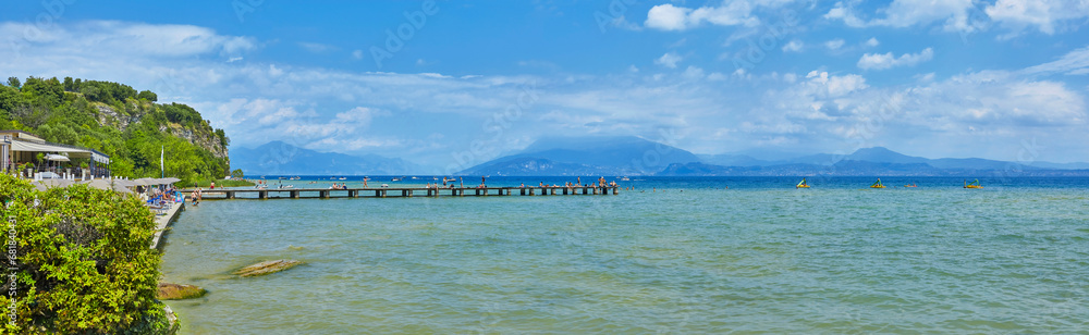 Beautiful panoramic view of the Lido delle Bionde beach on Lake Garda in Sirmione, province of Brescia, Italy.