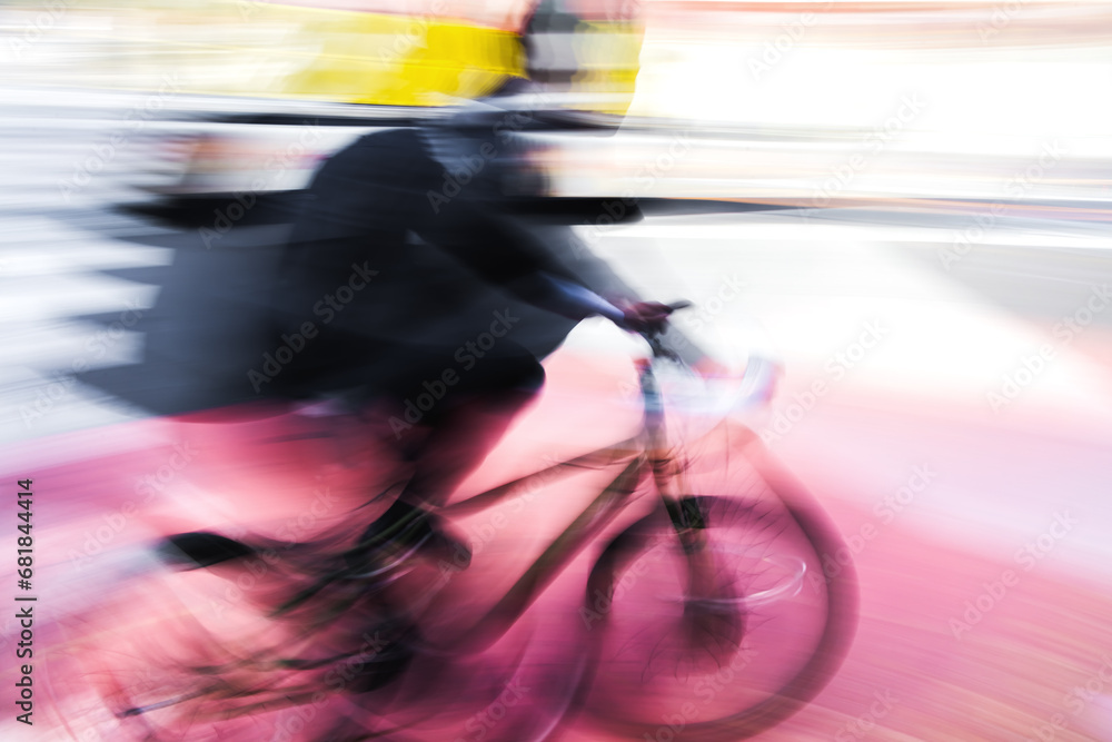 Obraz premium abstract photo of a cyclist in city traffic