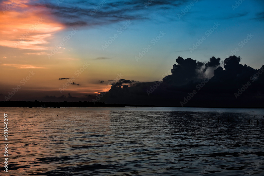 orange clouds at sunrise over the lake