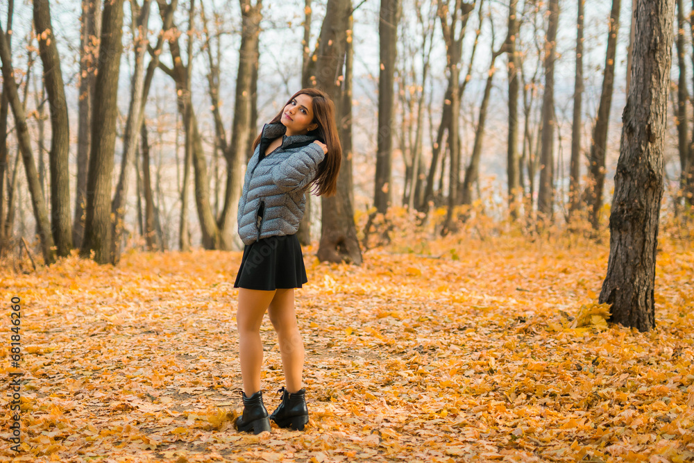 Rear view portrait of diversity young beautiful confident Indian Asian woman in fall outdoor. Happy and natural smiling female. Generation z and gen z youth concept Rear view portrait of diversity young beautiful confident Indian Asian woman in fall outdoor. Happy and natural smiling female. Generation z and gen z youth concept