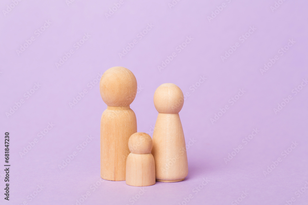 Wooden family figures on color background Wooden family figures on color background